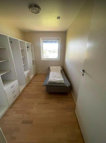 a small room with a bed and a window at Nautnes Seaside Villa in Nautnes