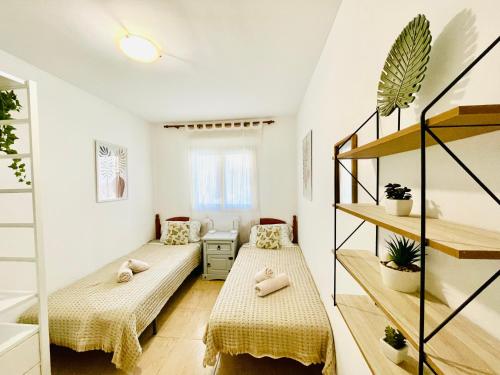 A bed or beds in a room at Rooftop Pool Apartment Corralejo