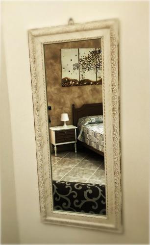 a picture of a bedroom with a bed in a mirror at La casa dei nonni in San Salvo
