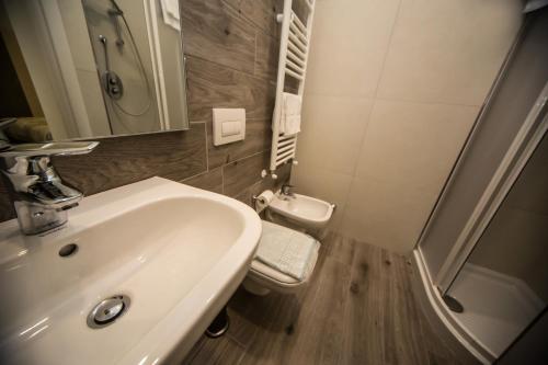 a bathroom with a sink and a toilet and a shower at B&B Corte sul Naviglio CIN I T 0 1 5 0 7 0 C 1 3 X U I L Q C V in Cernusco sul Naviglio