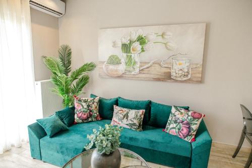 a living room with a blue couch and a table at PELAGIO APARTMENT 1 in Alexandroupoli