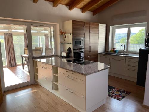a kitchen with a counter and a stove top oven at Oyer Ferienhaus in Oy-Mittelberg