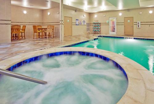 a pool with a hot tub in a hotel room at Holiday Inn Hotel & Suites Waco Northwest by IHG in Bellmead