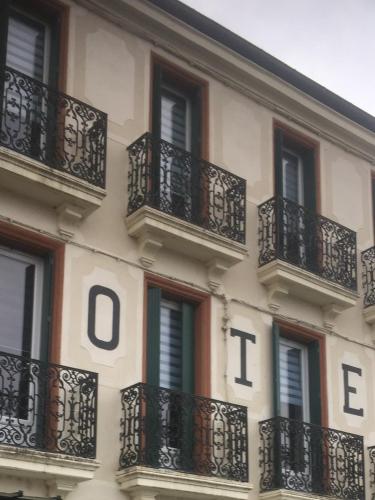 a building with balconies on the side of it at Le 9 en Cuisine in Rabastens