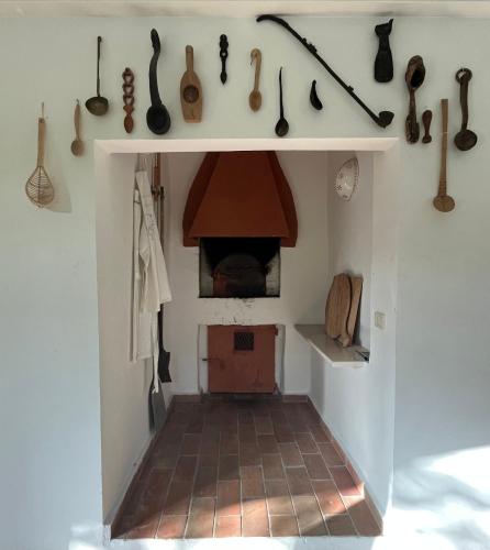 a room with a kitchen with a fireplace and utensils at Casa Sant Angelo in Pesaro
