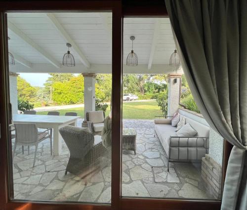 a screened in porch with a couch and a table at Casa Sant Angelo in Pesaro
