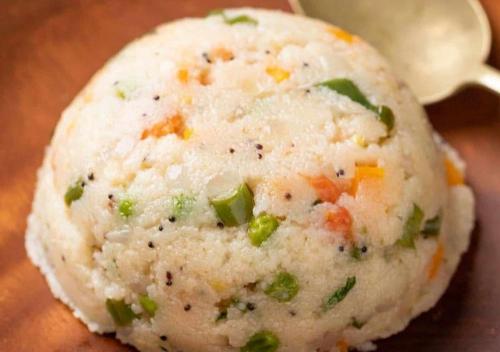 a close up of a ball of rice with vegetables on it at Baga View Inn in Baga