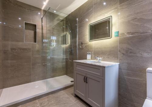 a bathroom with a shower and a sink and a shower at Marrington Hall in Chirbury