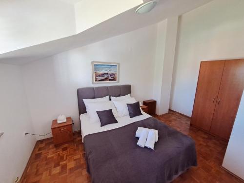 a bedroom with a bed with two towels on it at apartman Sanja-centar in Sveti Filip i Jakov
