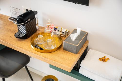 a table with glasses and a box on it at Naxos Marina Bay in Giardini Naxos