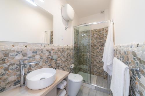 a bathroom with a toilet sink and a shower at Naxos Marina Bay in Giardini Naxos