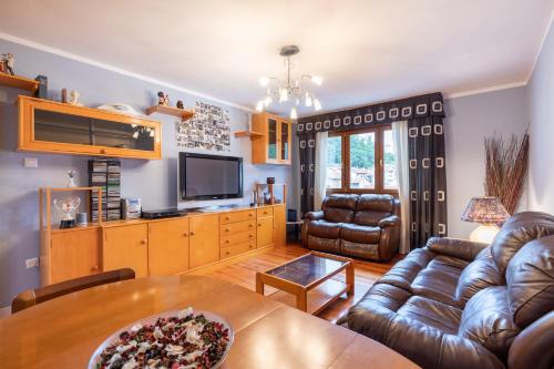 a living room with a couch and a table at Artibai - baskeyrentals in Ondárroa