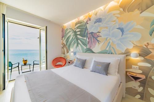 a bedroom with a large white bed with a flower mural at Naxos Marina Bay in Giardini Naxos