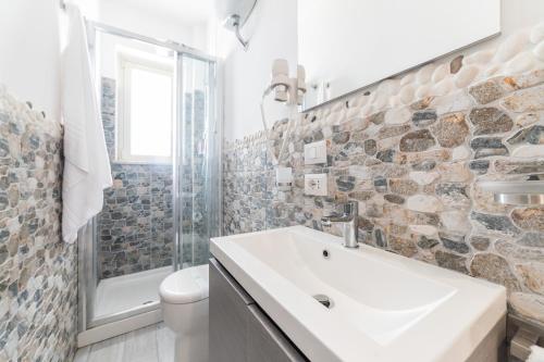 a bathroom with a sink and a toilet and a shower at Naxos Marina Bay in Giardini Naxos