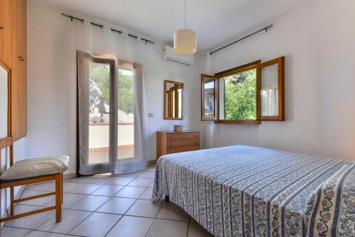 a bedroom with a bed and a window at Casa Castagnola in Marciana