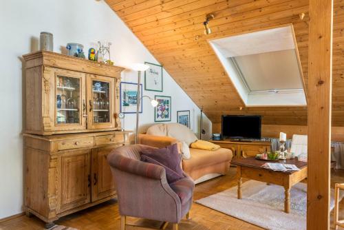 a living room with a couch and a tv at Rose Garden in Heiligenberg