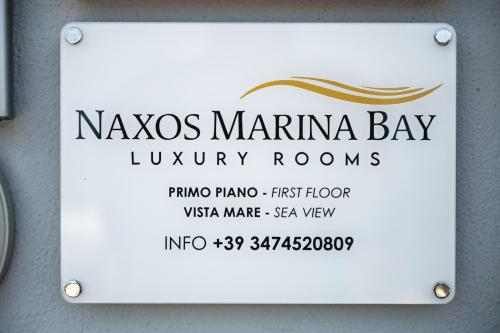 a sign for a kaya marina bay luxury rooms at Naxos Marina Bay in Giardini Naxos