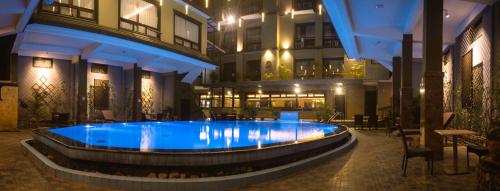 a large swimming pool in the middle of a building at Hotel Sarowar in Pokhara