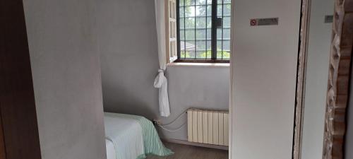 a small room with a window and a bed in it at Villa di Christian e Michelle in Rome