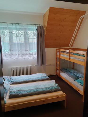 two bunk beds in a room with a window at Ski park Gruň in Staré Hamry