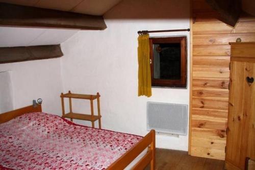 a bedroom with a bed and a window at Maison Larzac Cevennes Grand Gite 