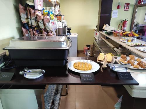 a kitchen with plates of food on a counter at Hotel A Bota in Sanxenxo