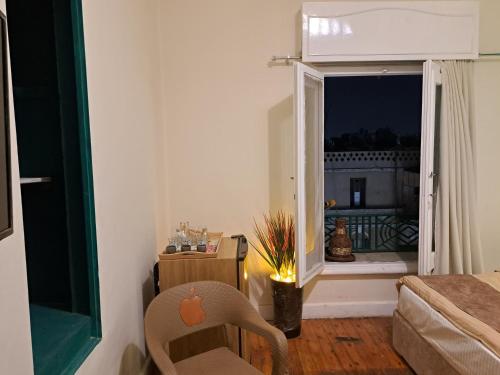 a living room with a chair and a window at downtown Family Suites in Cairo