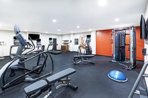 a gym with several treadmills and cardio machines at Candlewood Suites DFW Airport North - Irving by IHG in Irving