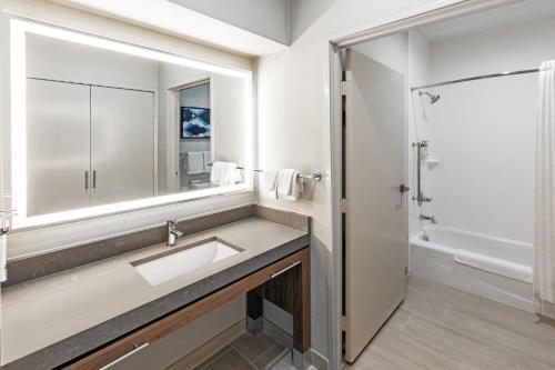 a bathroom with a sink and a mirror at Candlewood Suites DFW Airport North - Irving, an IHG Hotel in Irving