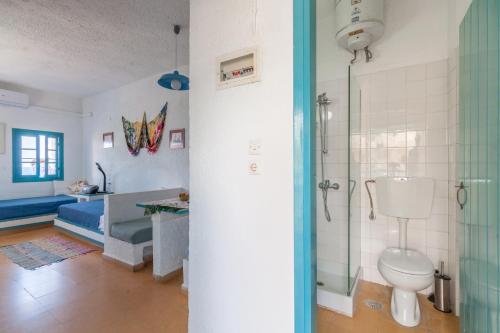 a bathroom with a shower and a toilet in a room at Sea view _ Cycladic Style House _ Steps to Sea in Sissi