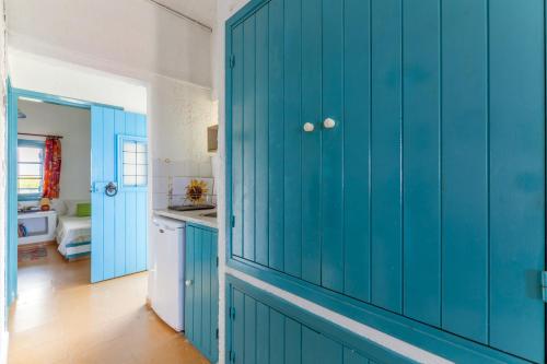 a blue cabinet in a kitchen with a sink at Sea view _ Cycladic Style House _ Steps to Sea in Sissi