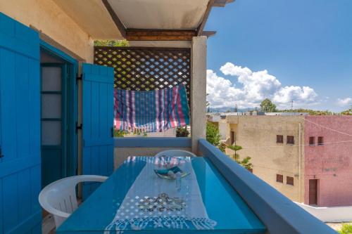 a blue table and chairs on a balcony at Sea view _ Cycladic Style House _ Steps to Sea in Sissi