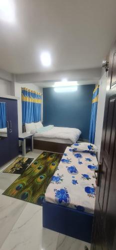 Zimmer mit 2 Betten und blauer Wand in der Unterkunft Hotel Homestay Inn in Thimi