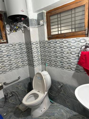 a bathroom with a toilet and a sink at Paridhi in Varanasi
