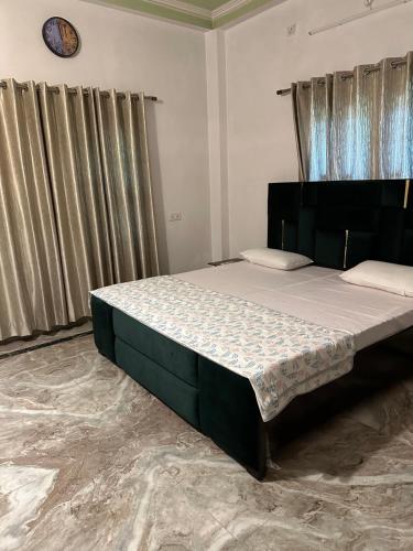 a bedroom with a large bed in a room at Paridhi in Varanasi