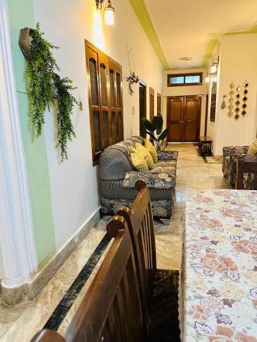 a living room with couches and a table and chairs at Paridhi in Varanasi