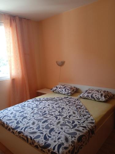 a bedroom with a bed and a window at APARTMENT 8 Primorsko АПАРТАМЕНТ 8 Приморско in Primorsko