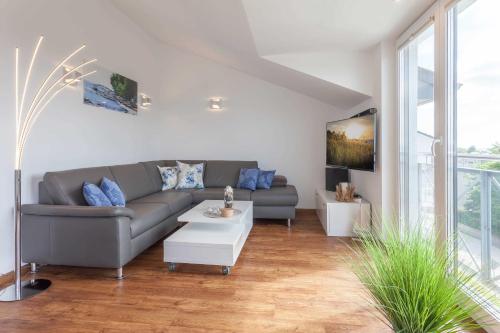a living room with a couch and a table at Villa Am alten Kreidebruch_ Pentho in Sassnitz
