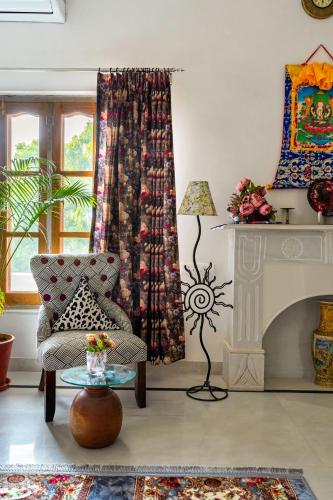 a living room with a chair and a fireplace at Castle Oodeypore A Boutique stay Udaipur in Udaipur