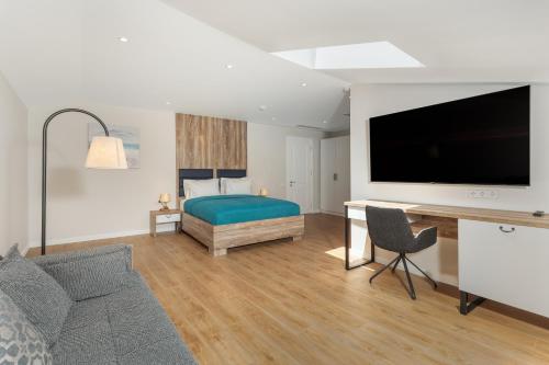 a bedroom with a bed and a flat screen tv at Boulevard Hotel Batumi in Batumi