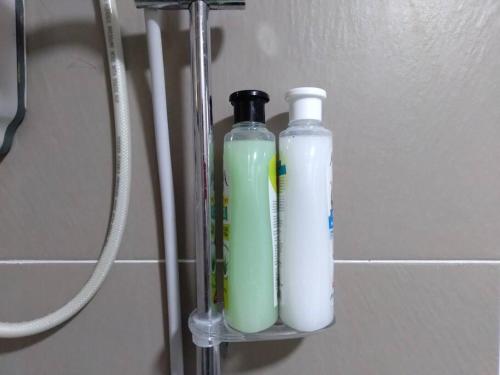 two bottles are sitting on a shelf in a bathroom at PlayStaytion Centura 3 Bedroom 2 Bathroom by RBNB in Kuala Lumpur