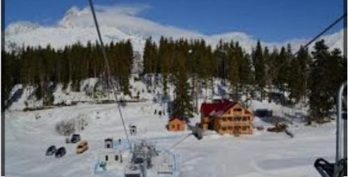 a ski lodge in the snow on a mountain at Mestia Roots in Mestia