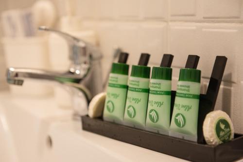 a rack of toothbrushes on a bathroom sink at Ktima Delmare Pantazara in Nea Skioni