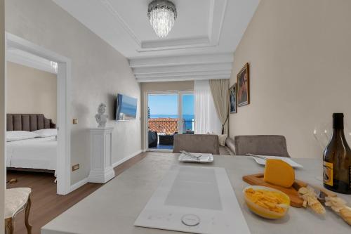 a white room with a bed and a table with food on it at Apartment Vranješ in Makarska