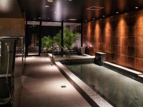a pool in the middle of a building at REF Okinawa Arena by VESSEL HOTELS in Okinawa City