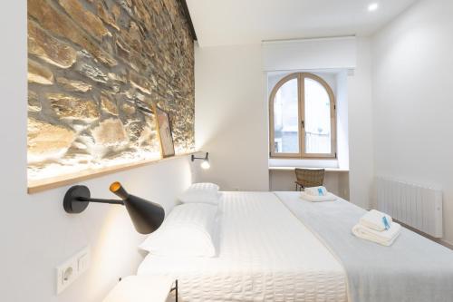 a bedroom with a bed and a painting on the wall at Zutabe - baskeyrentals in Azpeitia