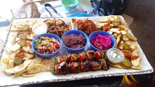a tray of food with different types of food at Dexamano Hotel & Resort in Lejamaní