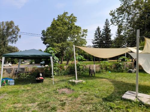 a gazebo and a tent in a yard at Caesar Residence in Budapest