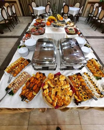 a long table with many different types of food on it at Hotel Beograd in Čačak
