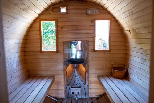 an inside view of a sauna in a wooden cabin at Domy z Bala - Domki ogrzewane - JACUZZI, SAUNA, lody, popcorn, ryba wedzona i ognisko w cenie! in Dziwnówek